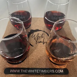 three glasses of wine on a cork coaster