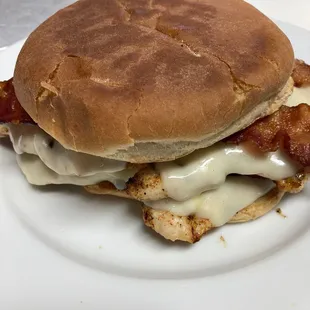 a bacon and cheese sandwich on a plate