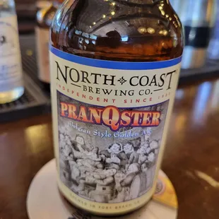 a bottle of beer on a coaster