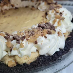 a pie with whipped cream and nuts