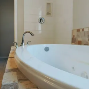 Shower and drop-in tub with some beautiful tile work chrome matching fixtures.