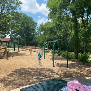 Part of the playground. A pavilion in the back ground. I feel like that merry go round has been closed for forever.