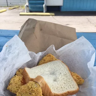 Catfish sandwich with onion, cheese mustard and hot sauce