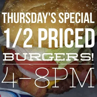 a burger with bacon, lettuce, tomato, and cheese