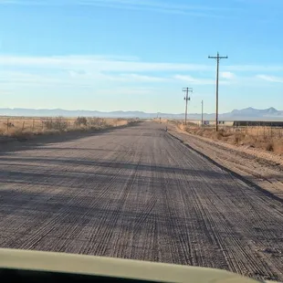 Approx 3 mi dusty road, minimal small gravel from hwy to access park. All cars should be fine traversing.