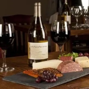 a table with wine and cheese