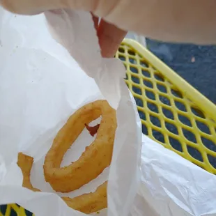 a hand holding a donut