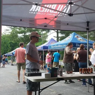 a man standing under a tent