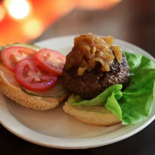 a hamburger with lettuce and tomato
