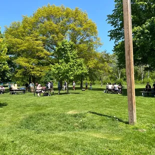 people sitting at picnic tables