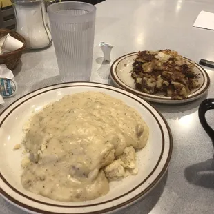 two plates of mashed potatoes and gravy