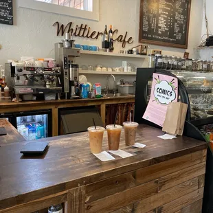 a counter with two cups of coffee on it