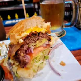 Egg, Bacon, Cheese Burger with Lettuce   Onion and Pickles. Ice Cold Draft.