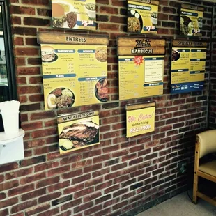 a brick wall with menus on it