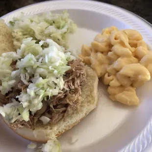 a pulled pork sandwich with macaroni and cheese