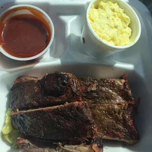 a tray of meat and sides