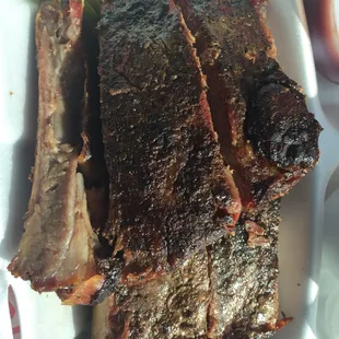 a plate of ribs and pickles