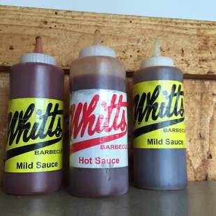 three bottles of hot sauce
