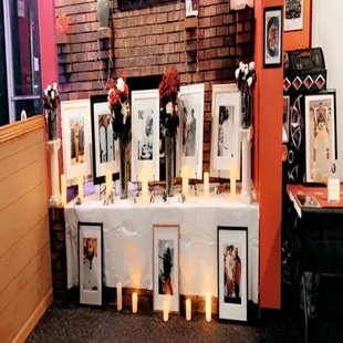 a table with pictures and candles