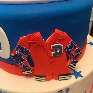 Detail of my son&apos;s letterman jacket attached to this beautiful cake!