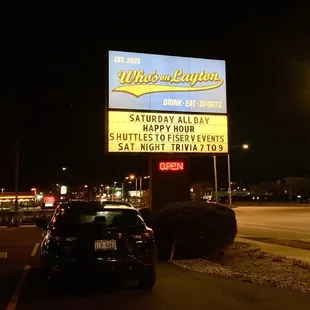 a car parked in front of a sign