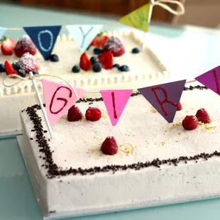 Two baby shower cakes with banner