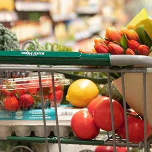 a shopping cart full of fruits and vegetables