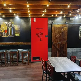 a table and chairs with a red door