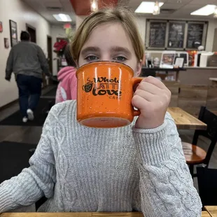 a girl holding a coffee mug