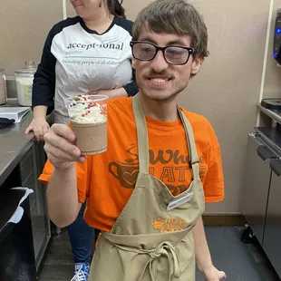 a man holding a cup of coffee