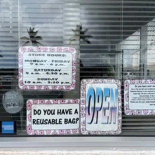 a storefront window with a sign that says, do you have a reusable bag?