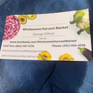 a hand holding a business card