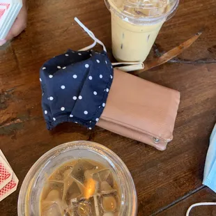 a cup of iced coffee and a wallet on a table