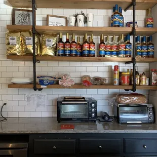 a kitchen with a microwave, toaster, toaster and other items