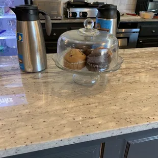 a cupcake and muffins on a counter