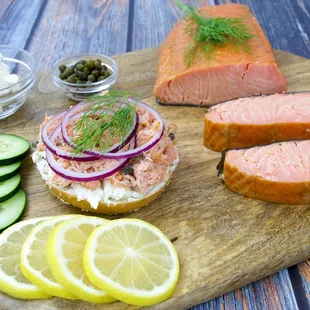 Kippered salmon salad sandwich on a sesame bagel and hand sliced kippered salmon.