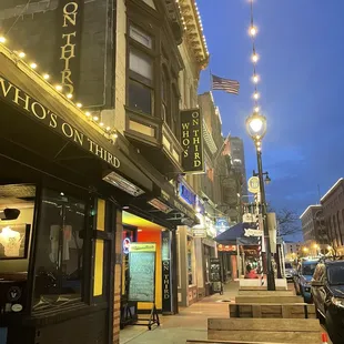 Cute and inviting storefront, with seating on the sidewalk for a warmer night