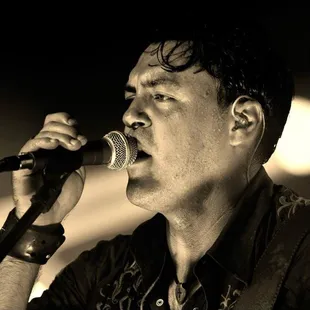 a man singing into a microphone