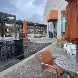 a patio area with tables and chairs