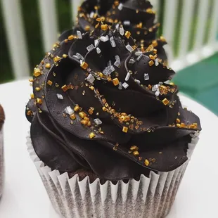 a cupcake with chocolate frosting and sprinkles