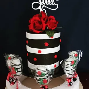 a black and white cake with red roses