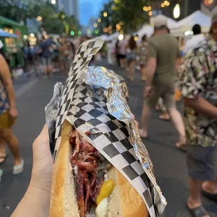 a person holding a sandwich in their hand