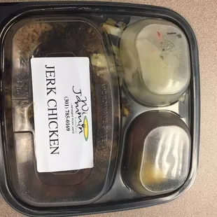 Jerk chicken with rice and peas, cabbage, and plantains