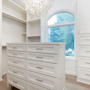 a walk - in closet with a chandelier