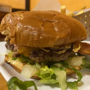 Texas Burger with bacon, onion rings, cheese. Comes with fries.