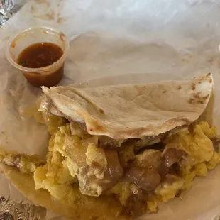 Breakfast taco with eggs, potato, beans and cheese