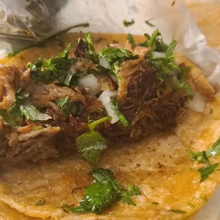 Carnitas Tacos with onions, cilantro, and excellent hot sauce.