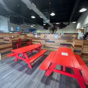 a red picnic table and benches