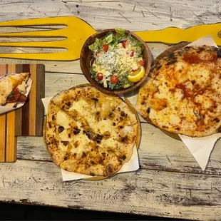 Cheese pizza, garlic cheesy bread, Caesar salad and turkey club sandwich.