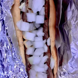 a hot dog with onions on it